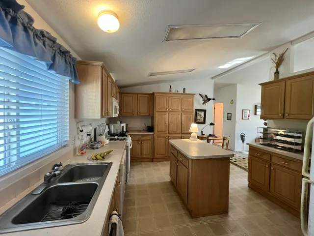 a kitchen that has a sink and a stove in it