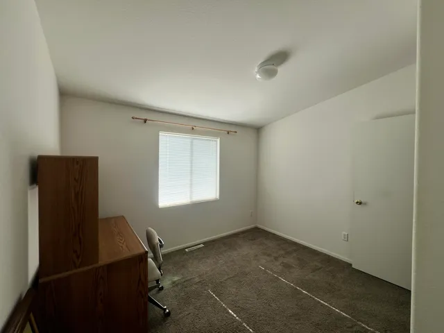 a view of a room with workspace and windows