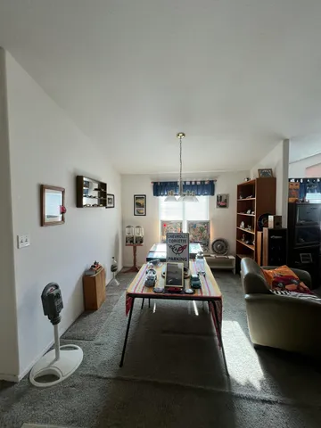 a room with furniture a air conditioner and a window