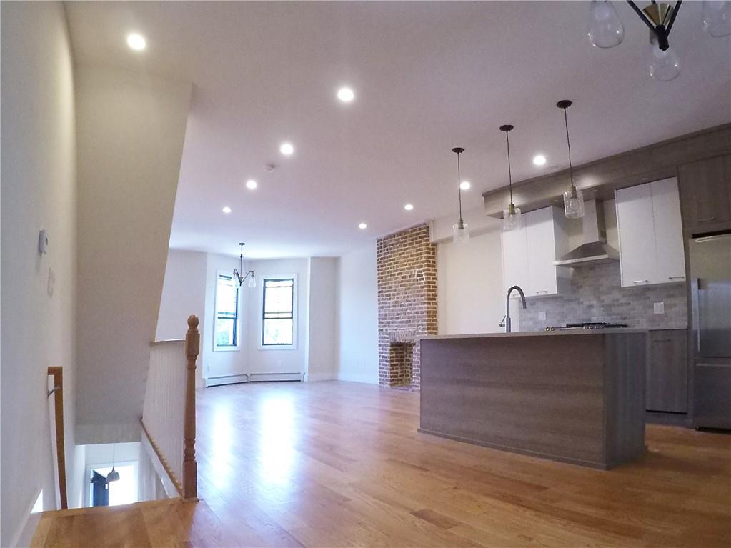 38 Troy Avenue Brooklyn, NY 11213 - Photo 11 of 16 a view of a kitchen with a sink and a refrigerator
