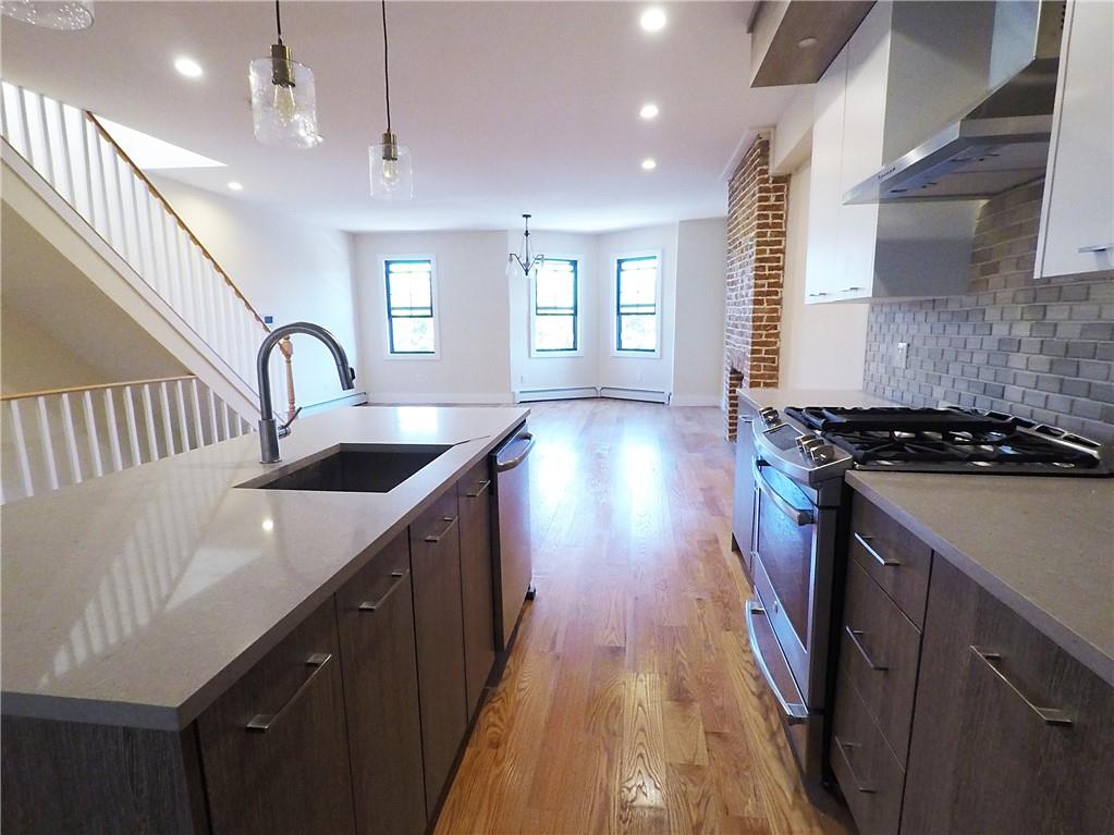 38 Troy Avenue Brooklyn, NY 11213 - Photo 14 of 16 a kitchen with sink a stove and cabinets