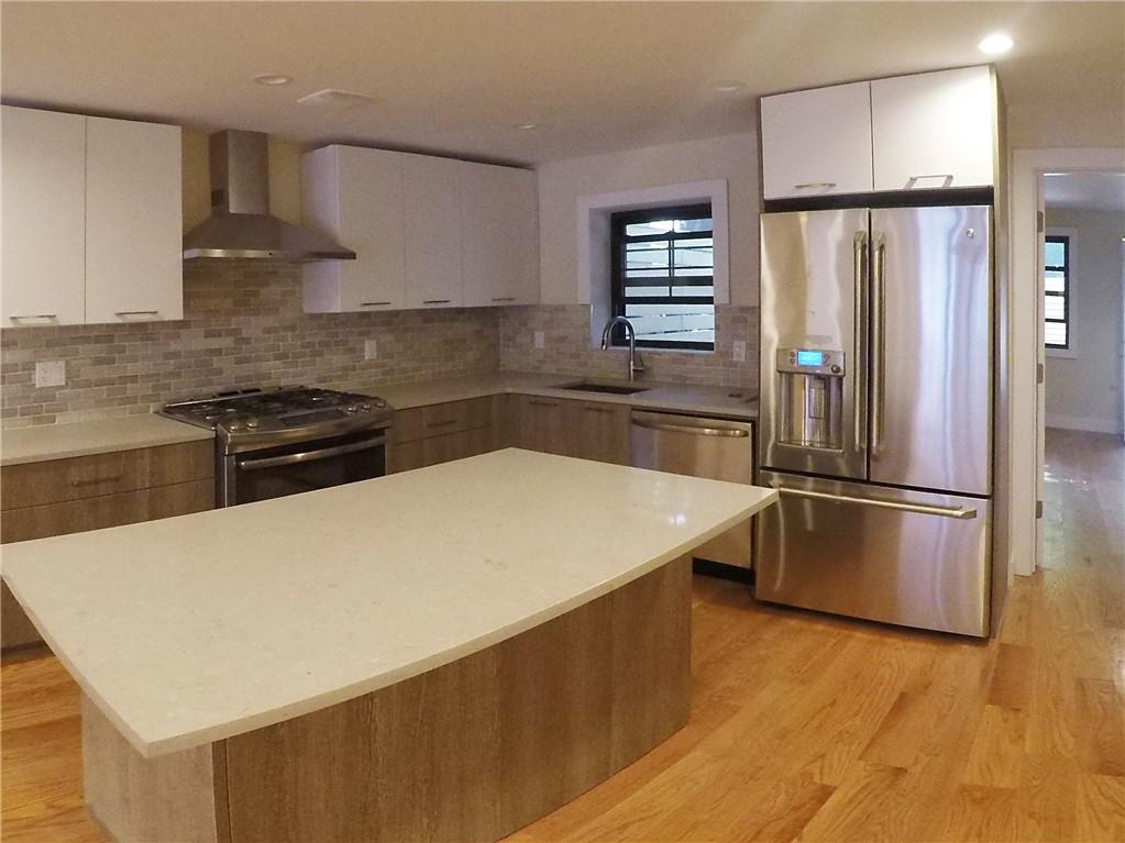 38 Troy Avenue Brooklyn, NY 11213 - Photo 3 of 16 a kitchen with a refrigerator and a stove top oven