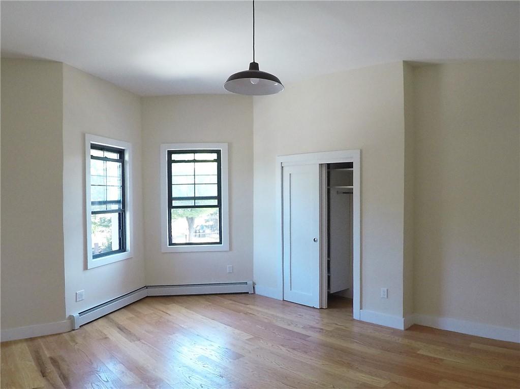 38 Troy Avenue Brooklyn, NY 11213 - Photo 4 of 16 a view of an empty room with wooden floor and a window