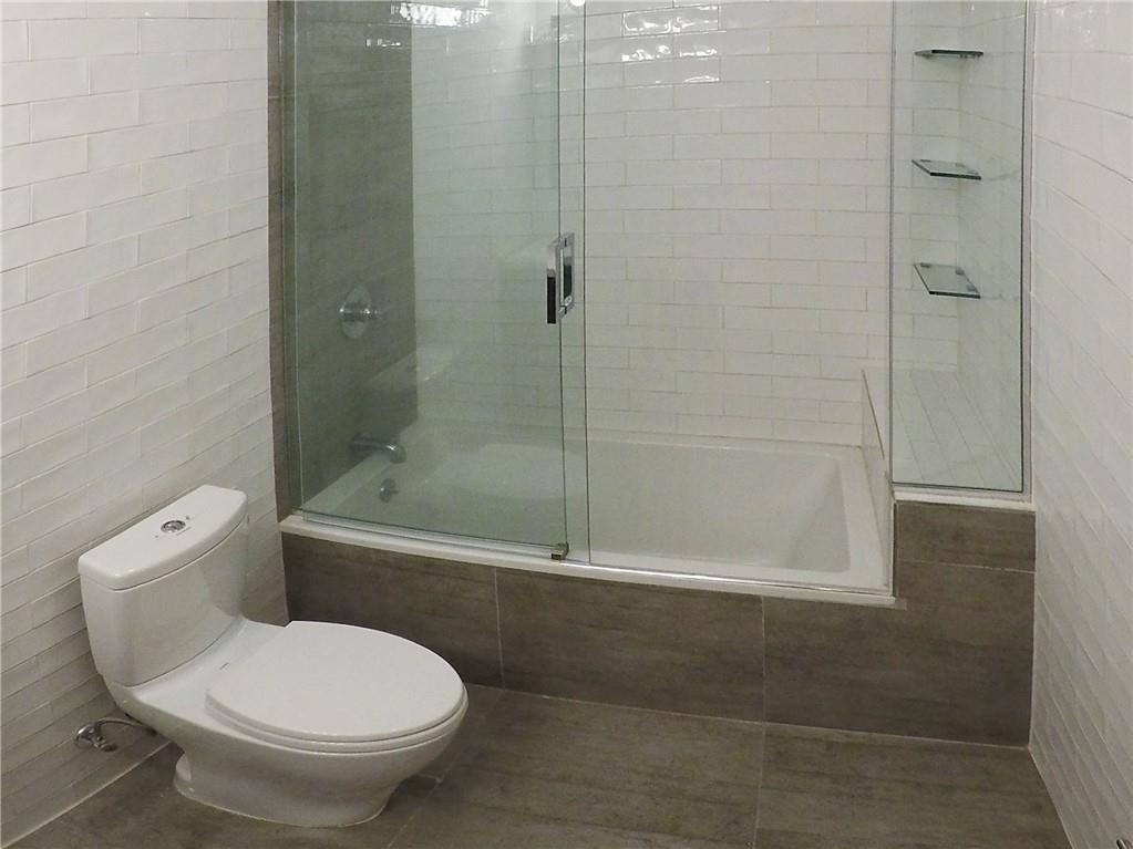 38 Troy Avenue Brooklyn, NY 11213 - Photo 5 of 16 a bathroom with a toilet and a shower