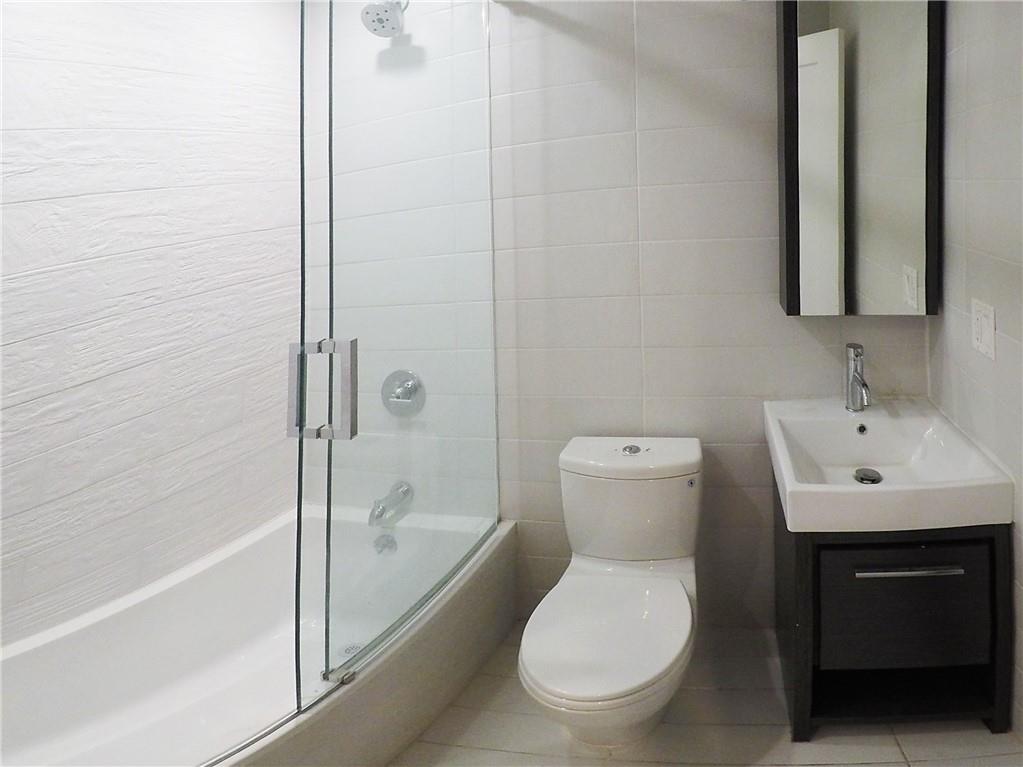 38 Troy Avenue Brooklyn, NY 11213 - Photo 6 of 16 a bathroom with a toilet a sink and bathtub