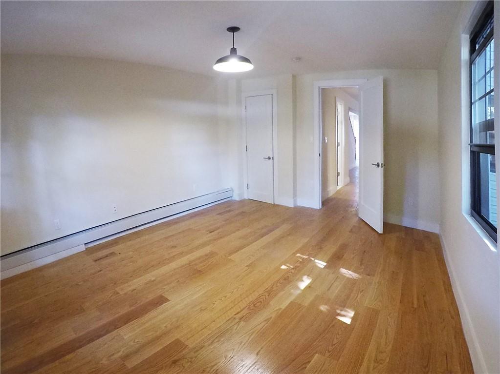 38 Troy Avenue Brooklyn, NY 11213 - Photo 9 of 16 a view of empty room with window and wooden floor