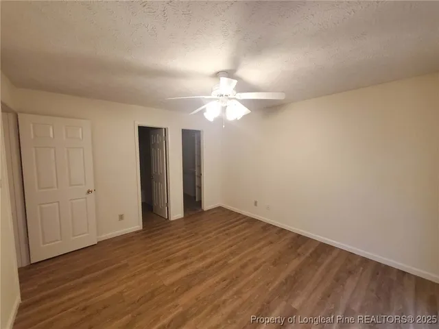 a view of balcony with wooden floor and fence