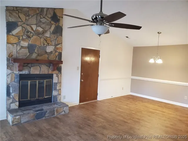 a view of an empty room with a fireplace