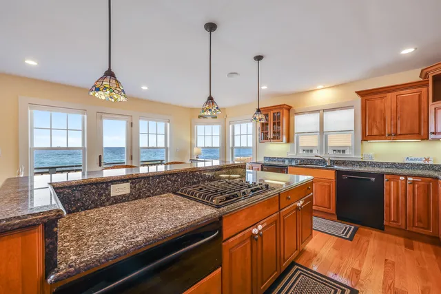a kitchen with stainless steel appliances granite countertop a stove and a sink