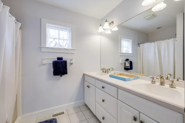 a bathroom with a double vanity sink and mirror