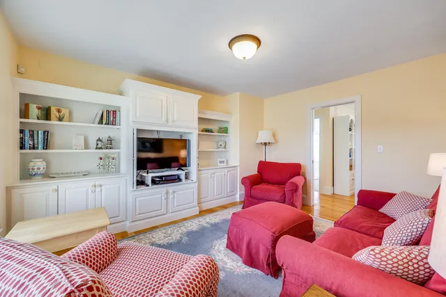 a bedroom with furniture and a flat screen tv