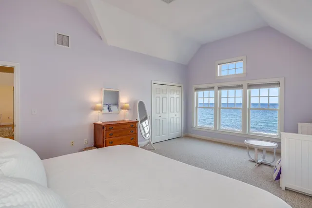 a bedroom with a bed and a large window