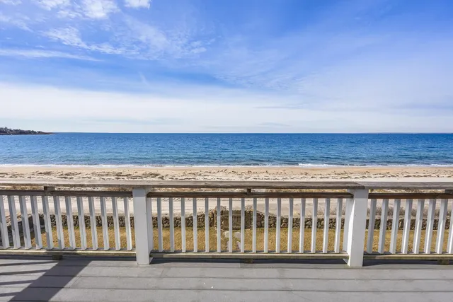 an aerial view of a house with a ocean view