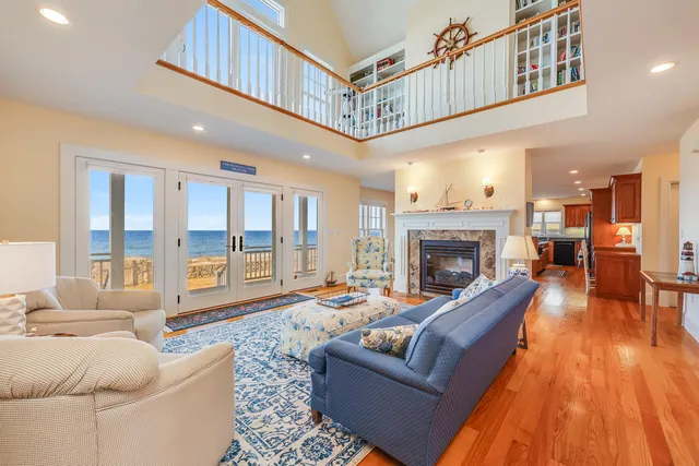 a living room with furniture a fireplace and a large window