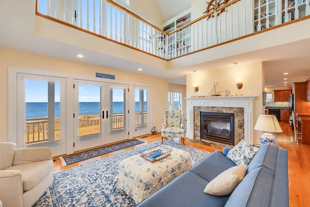 a living room with furniture a rug and a fireplace