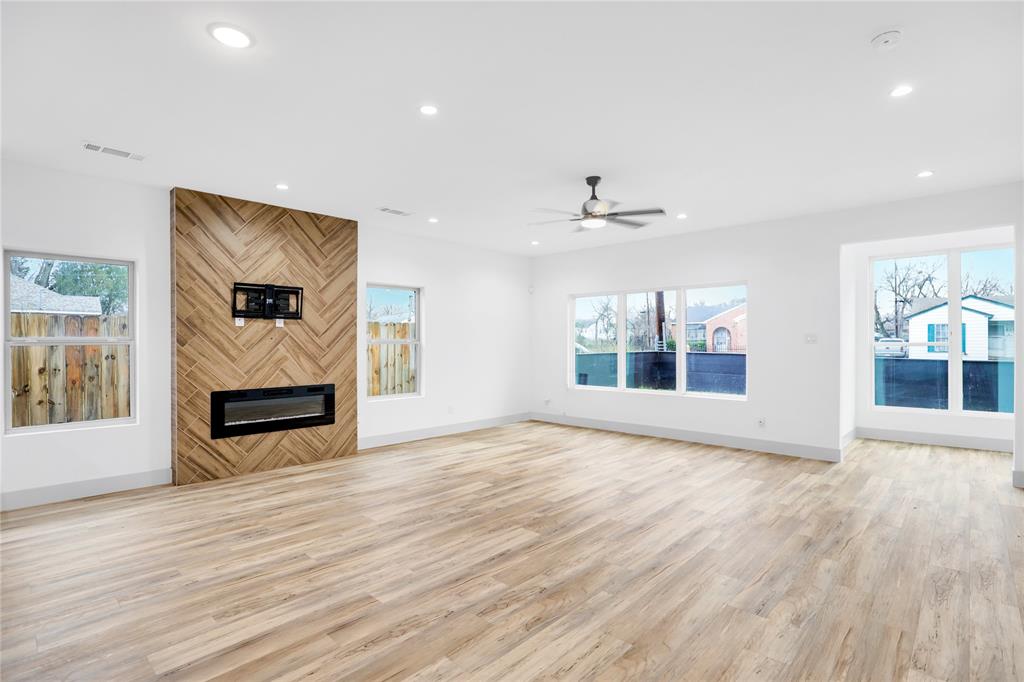 2606 Fordham Road Dallas, TX 75216 - Photo 14 of 19 Spacious living area featuring light wood-finish flooring, recessed lighting, and a modern ceiling fan