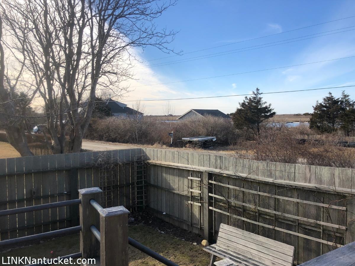 8 M Street Nantucket, MA 02554 - Photo 3 of 20 a view of balcony with wooden floor and fence
