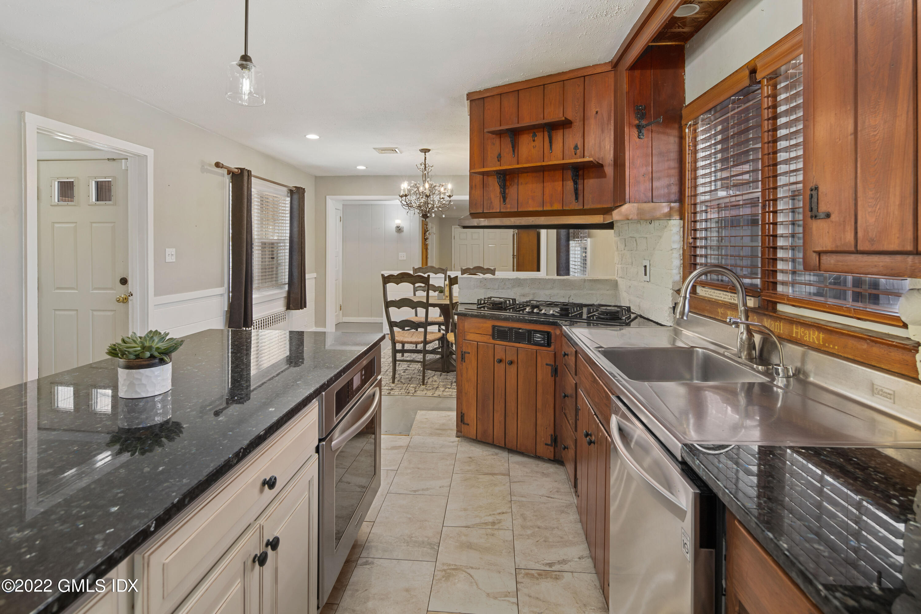 66 Simsbury Road Stamford, CT 06905 - Photo 13 of 40 a kitchen with stainless steel appliances granite countertop a sink stove and cabinets