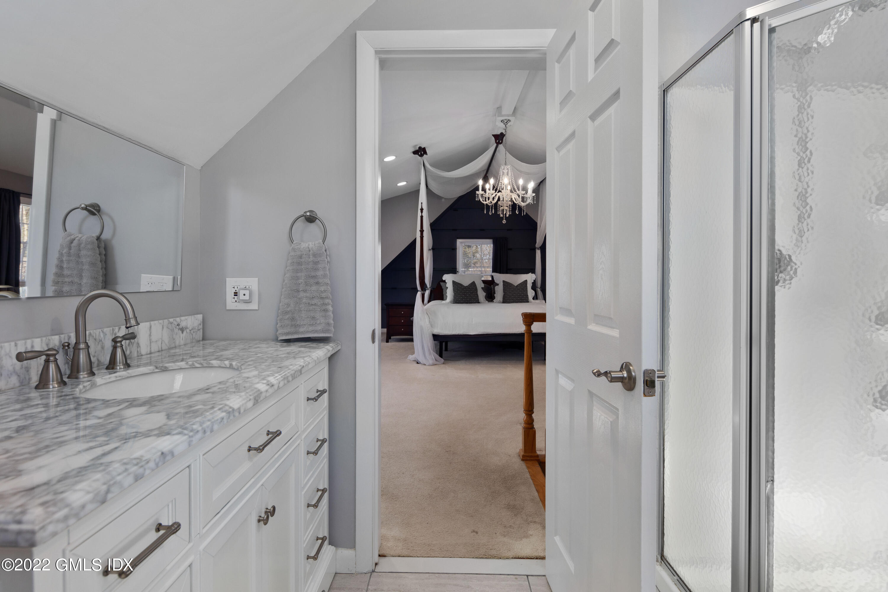 66 Simsbury Road Stamford, CT 06905 - Photo 20 of 40 a en suite bathroom with a granite countertop sink and a mirror