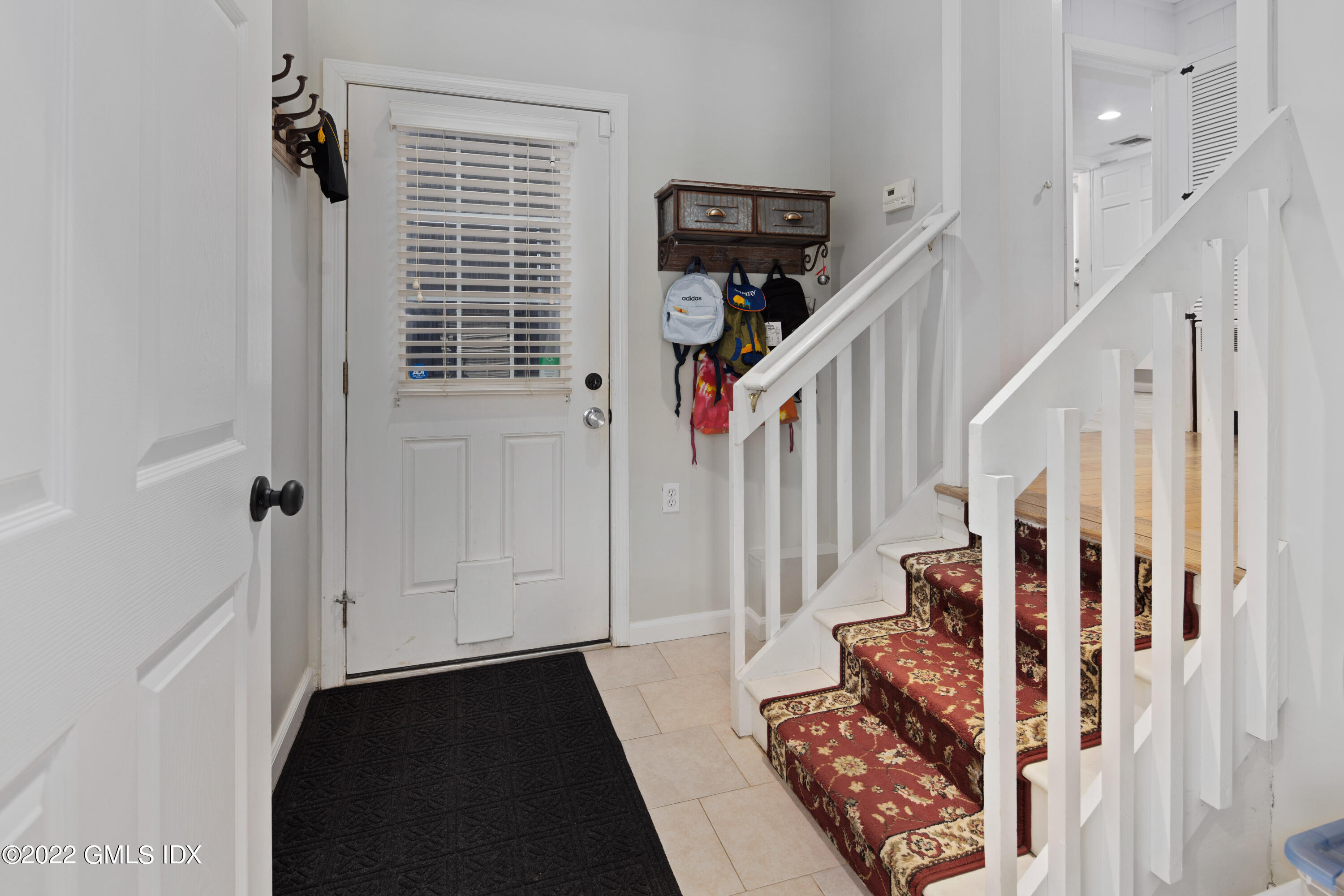 66 Simsbury Road Stamford, CT 06905 - Photo 27 of 40 a view of a hallway with wooden floor and staircase