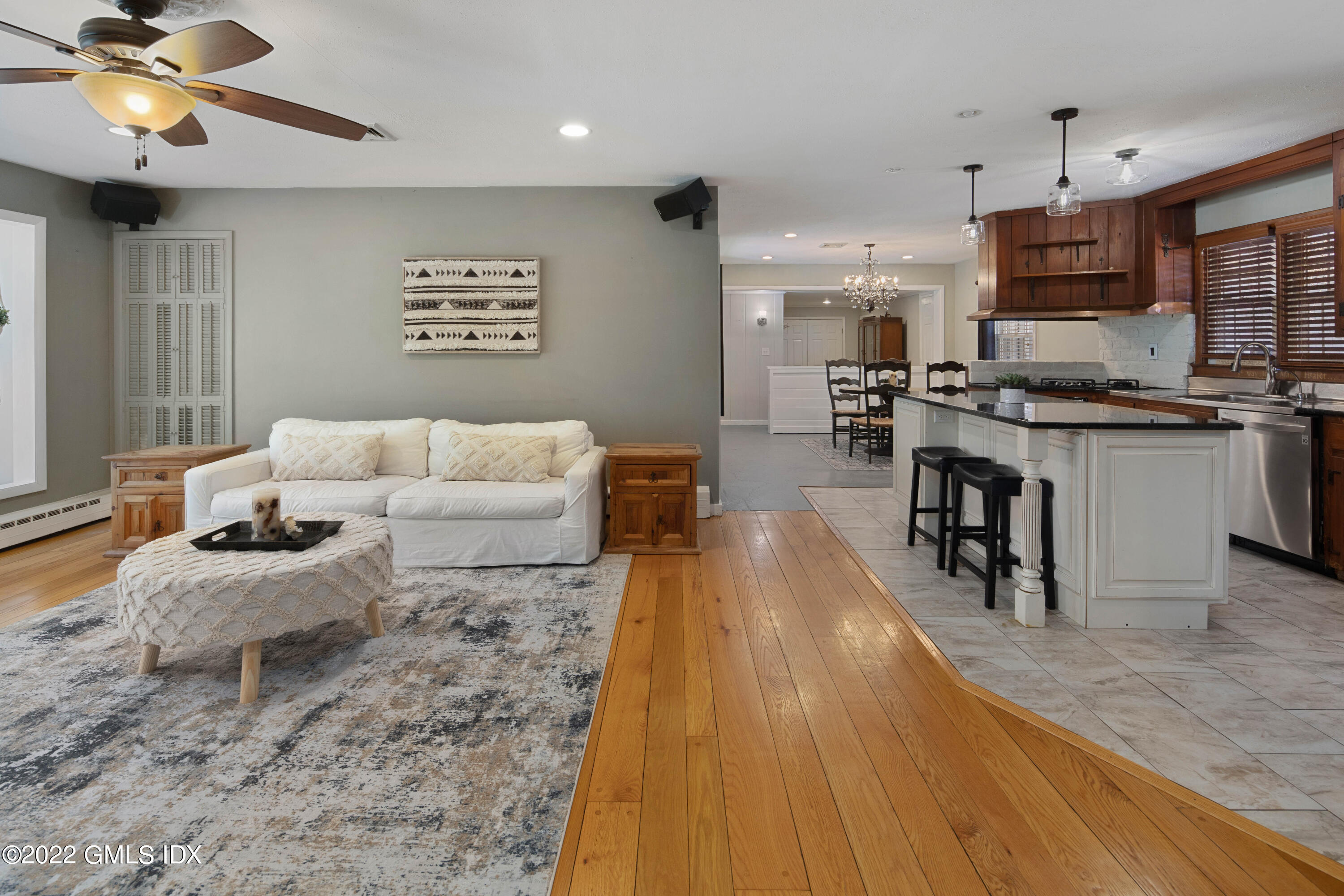 66 Simsbury Road Stamford, CT 06905 - Photo 4 of 40 a living room with kitchen island furniture and a wooden floor