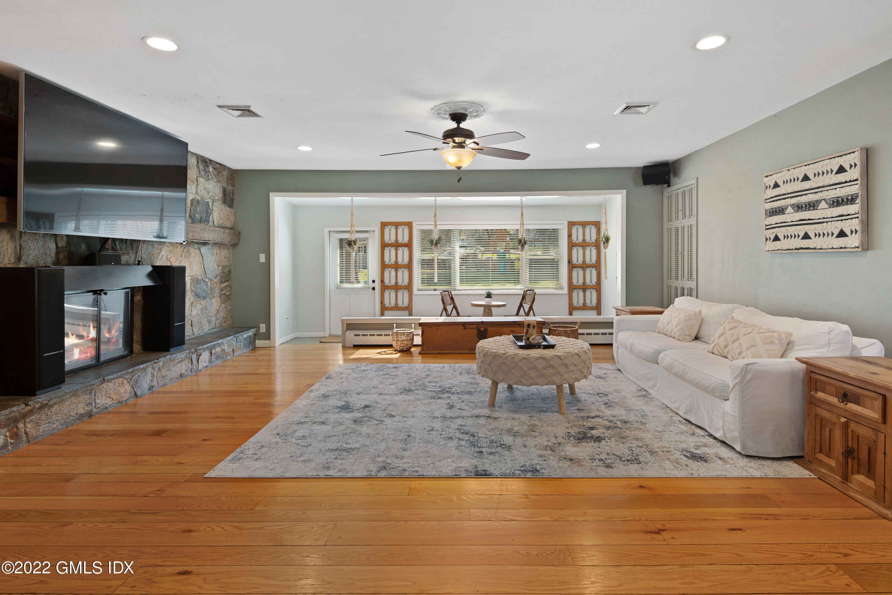 66 Simsbury Road Stamford, CT 06905 - Photo 5 of 40 a living room with fireplace furniture and a wooden floor