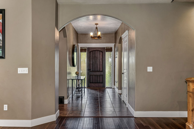288 525 South Providence, UT 84332 - Photo 13 of 71 Arched entryway with dark wood-finish flooring transitioning to large format tile