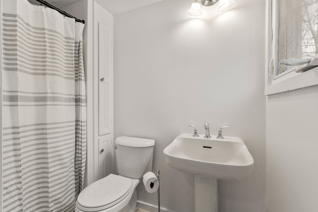 70 Bardin Street Hanover, MA 02339 - Photo 11 of 29 a bathroom with a sink a toilet and shower curtain