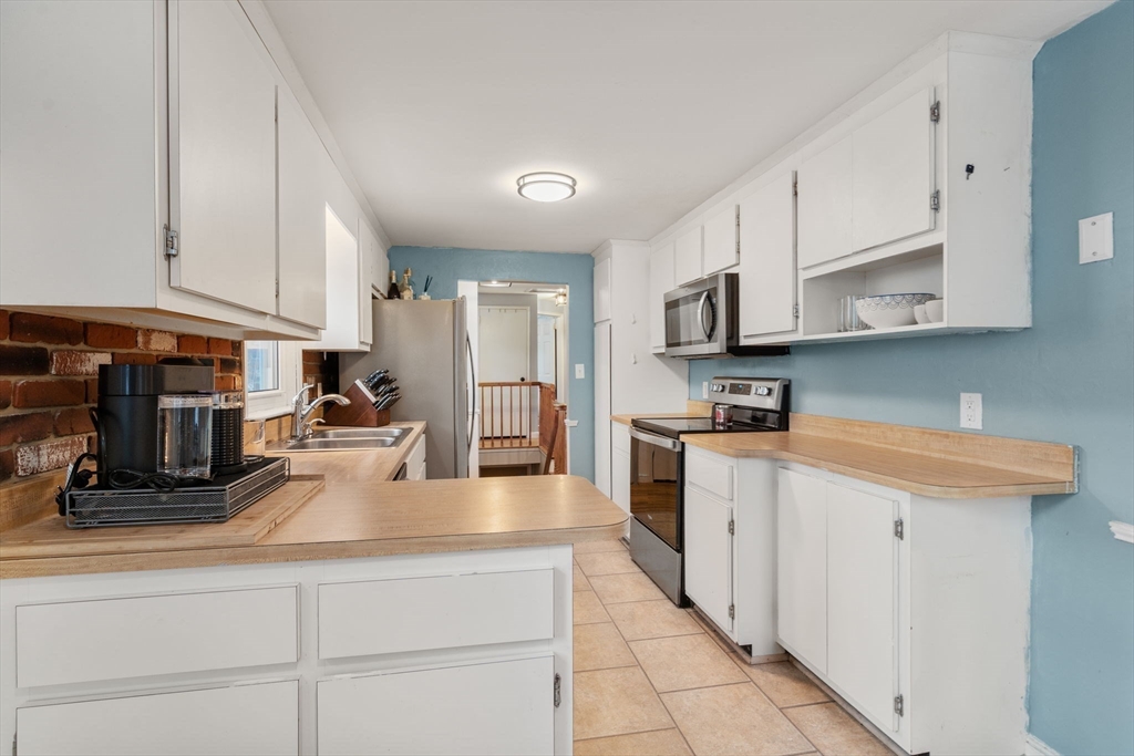 70 Bardin Street Hanover, MA 02339 - Photo 15 of 29 a kitchen with stainless steel appliances granite countertop a sink a stove and cabinets