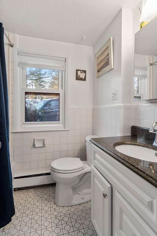 70 Bardin Street Hanover, MA 02339 - Photo 21 of 29 a bathroom with a granite countertop toilet a sink and a window