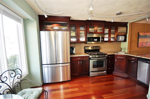 9-2 Deer Path, Unit 2 Maynard, MA 01754 - Photo 1 of 1 a kitchen with granite countertop a refrigerator stove and wooden floor