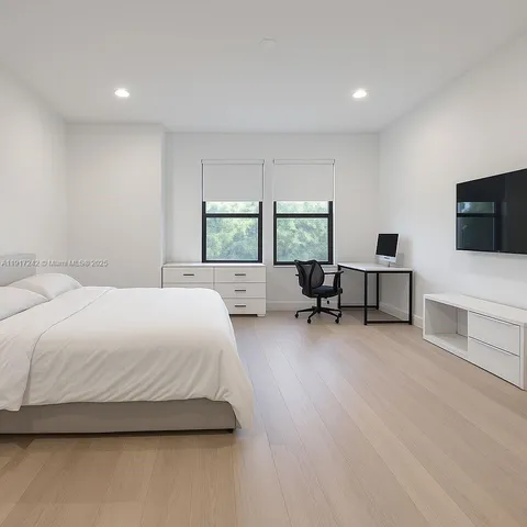a view of walk in closet with clothes