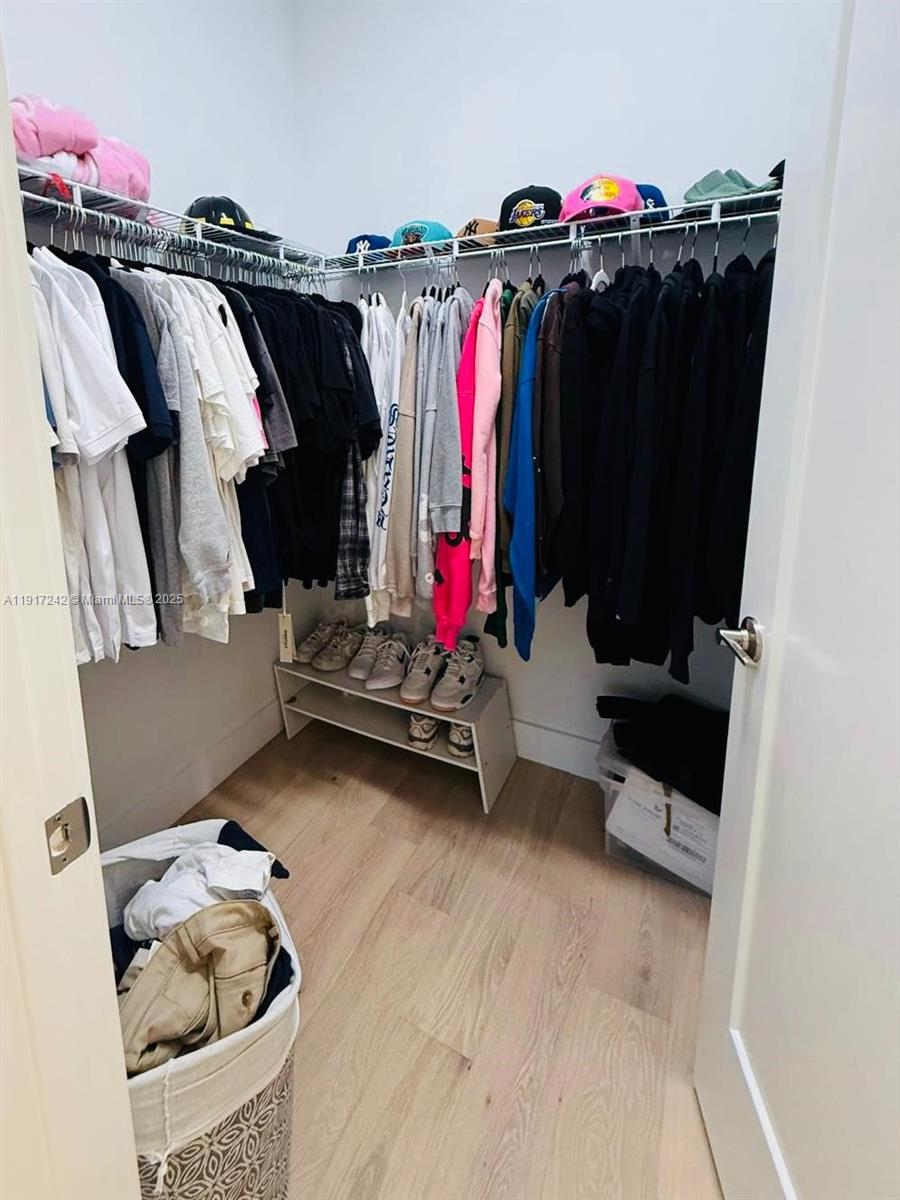 8185 Crystal Downs Avenue Boca Raton, FL 33434 - Photo 15 of 27 a view of walk in closet with clothes and shoes