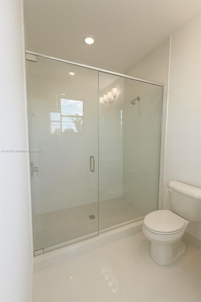 8185 Crystal Downs Avenue Boca Raton, FL 33434 - Photo 18 of 27 a bathroom with a shower a toilet and a shower