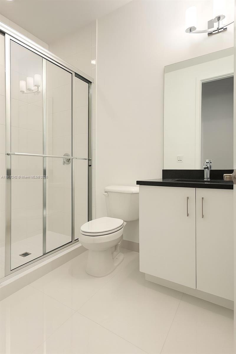 8185 Crystal Downs Avenue Boca Raton, FL 33434 - Photo 19 of 27 a white toilet sitting next to a bathroom sink