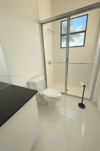 a bathroom with a toilet a sink and shower