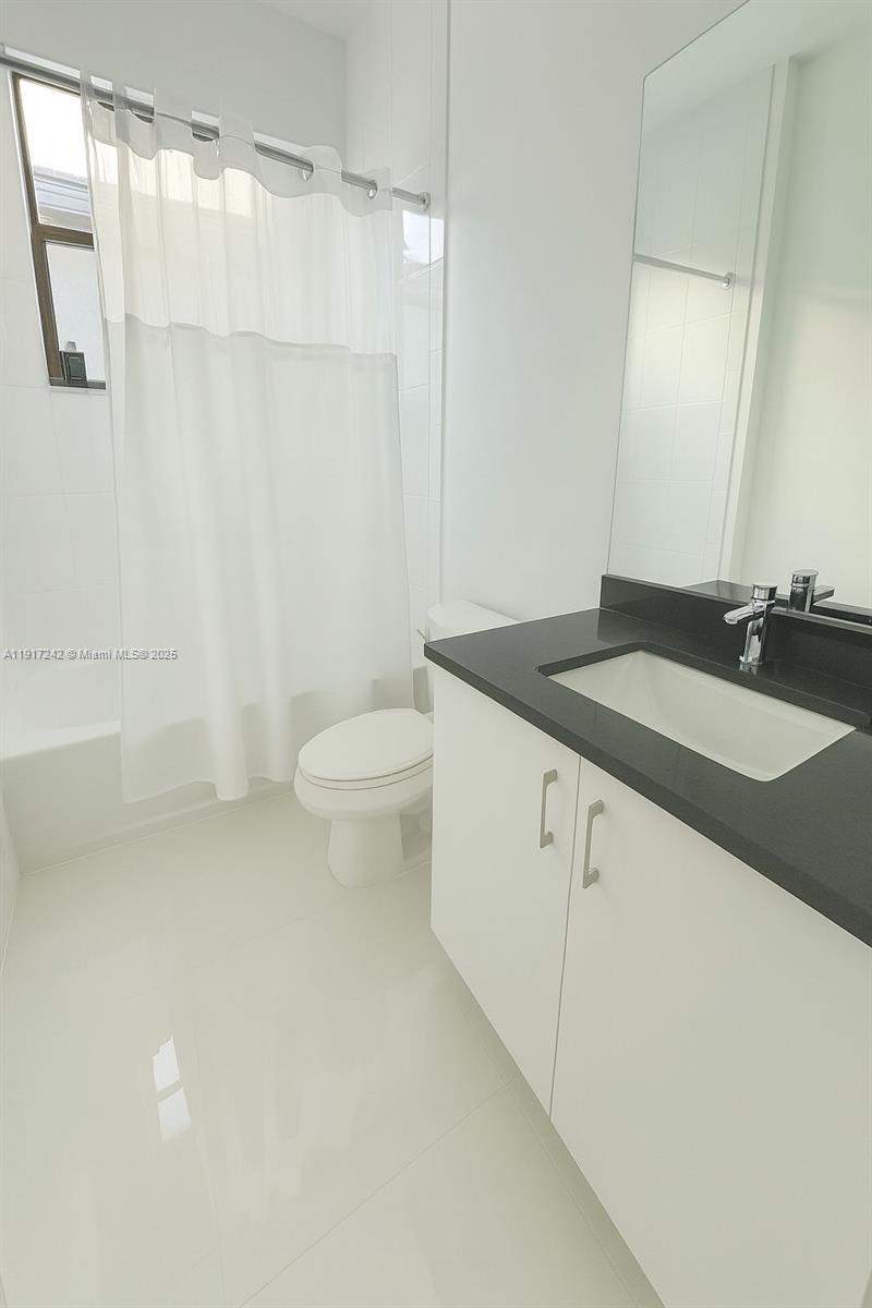 8185 Crystal Downs Avenue Boca Raton, FL 33434 - Photo 22 of 27 a bathroom with a granite countertop sink toilet and shower