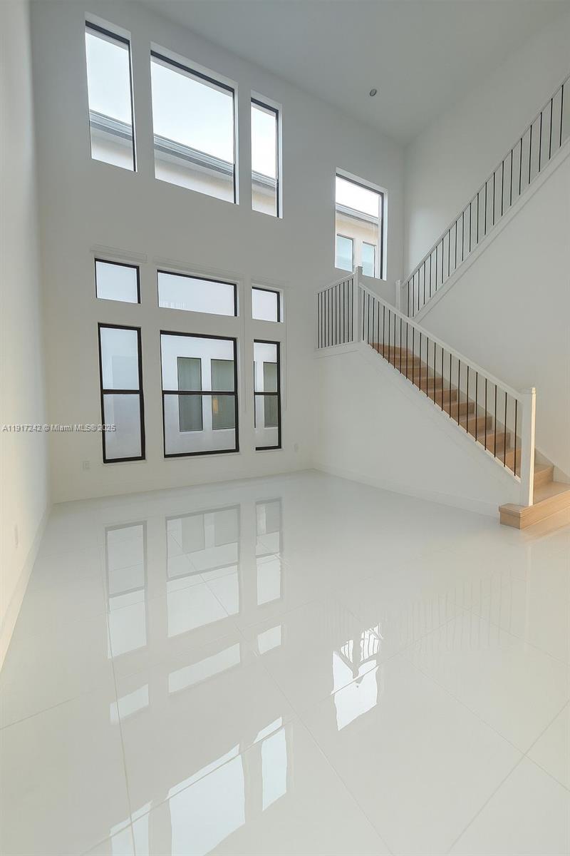 8185 Crystal Downs Avenue Boca Raton, FL 33434 - Photo 3 of 27 a view of an empty room with stairs