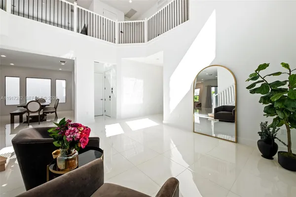 a living room with furniture large windows and a flat screen tv