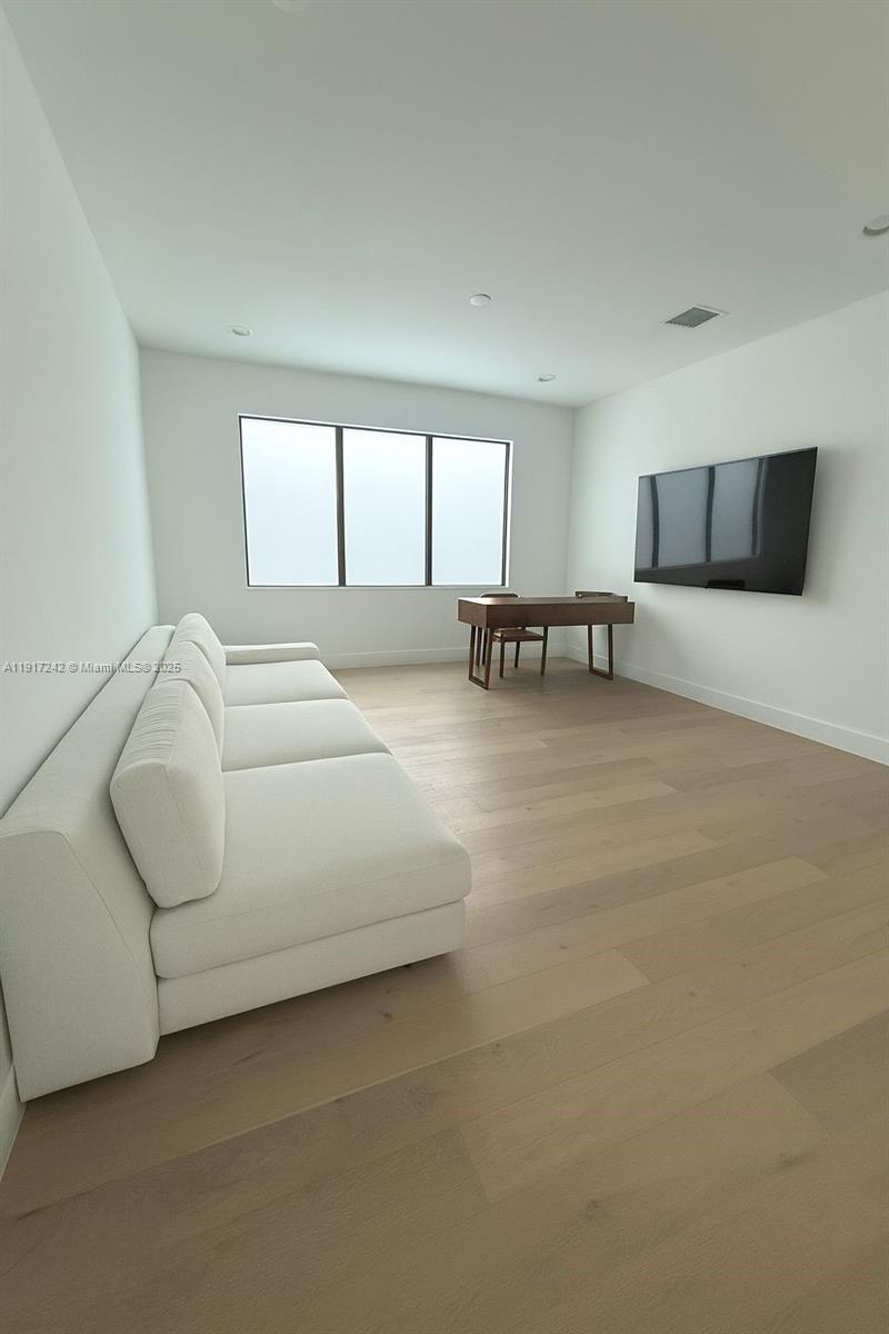 8185 Crystal Downs Avenue Boca Raton, FL 33434 - Photo 5 of 27 a living room with furniture and a flat screen tv