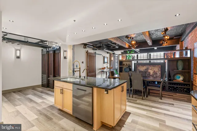 a kitchen with stainless steel appliances granite countertop a sink and a refrigerator