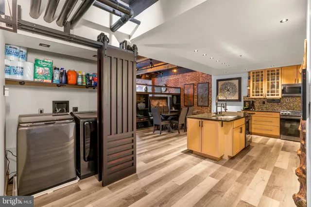 a kitchen with stainless steel appliances granite countertop a refrigerator and a sink