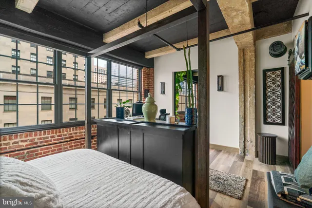 a bedroom with furniture and a window