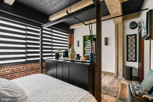 a bedroom with a bed dresser and a window