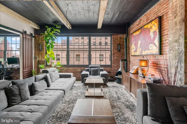 a living room with furniture and large windows