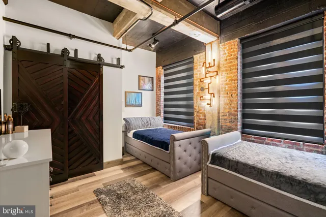 a bedroom with a bed a couch and a window