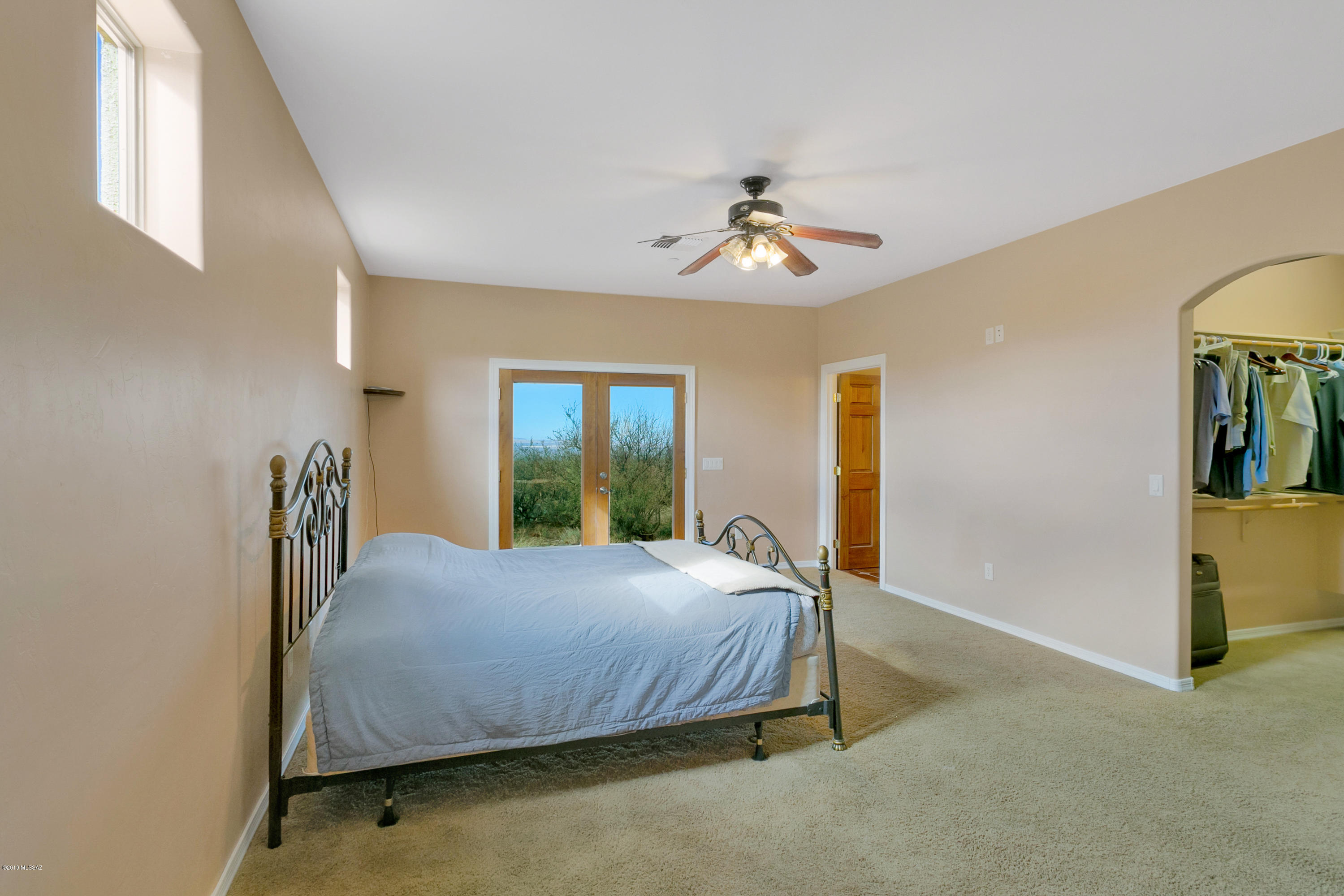 21960 South Helvetia Road Sahuarita, AZ 85629 - Photo 20 of 29 a bedroom with a bed and a chandelier