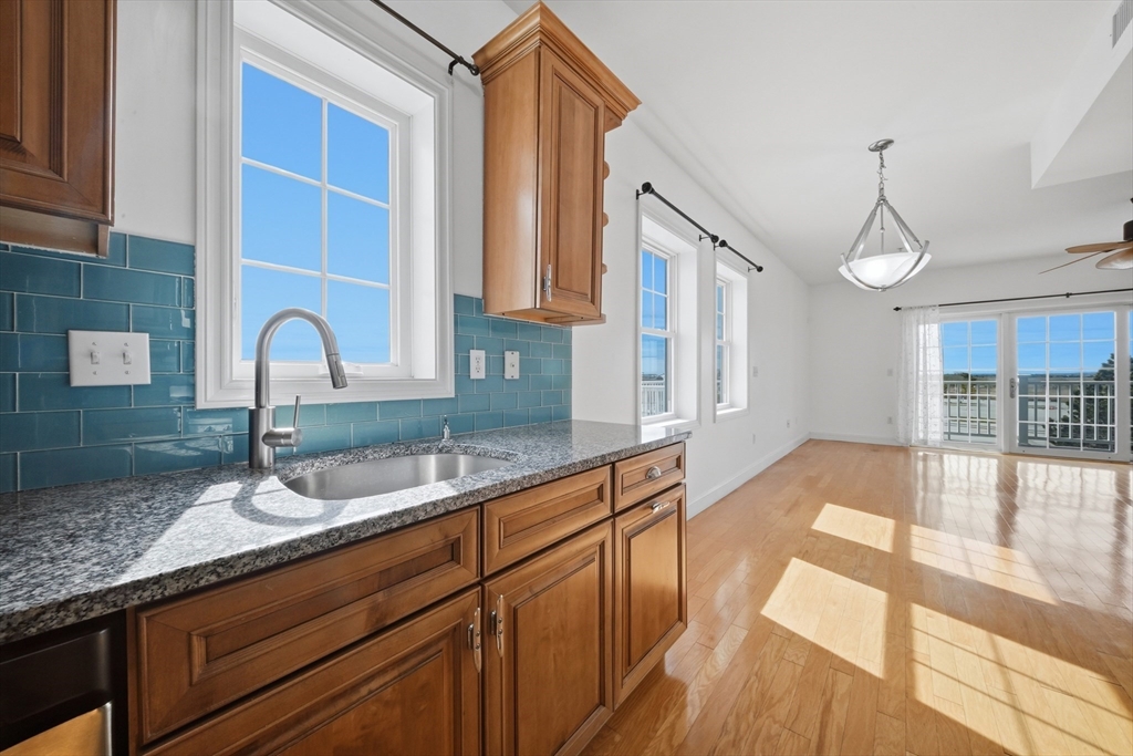 233 Beach Road, Unit A11 Salisbury, MA 01952 - Photo 6 of 37 a kitchen with granite countertop a sink and cabinets