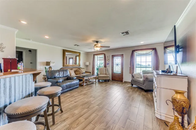 a living room with furniture and wooden floor