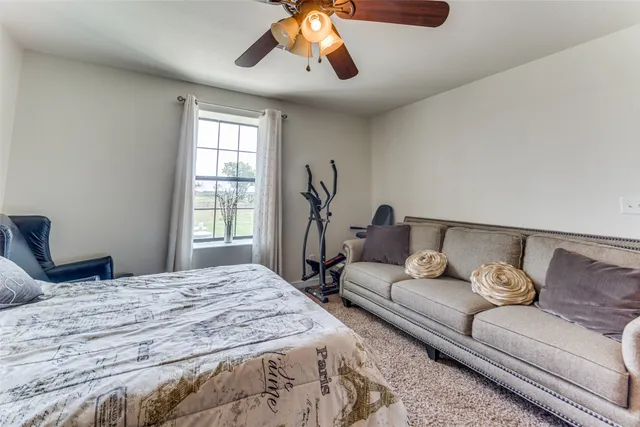 a bedroom with a bed couch and window